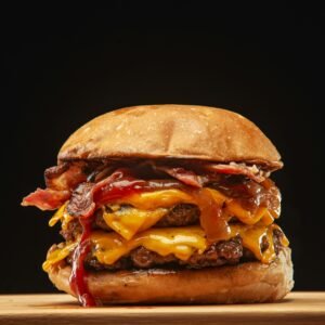 Indulge in a juicy double cheeseburger with bacon and melted cheese, perfect for food lovers.