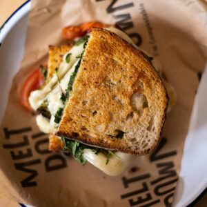Warm grilled cheese sandwich with herbs and tomatoes served in a Dublin cafe.